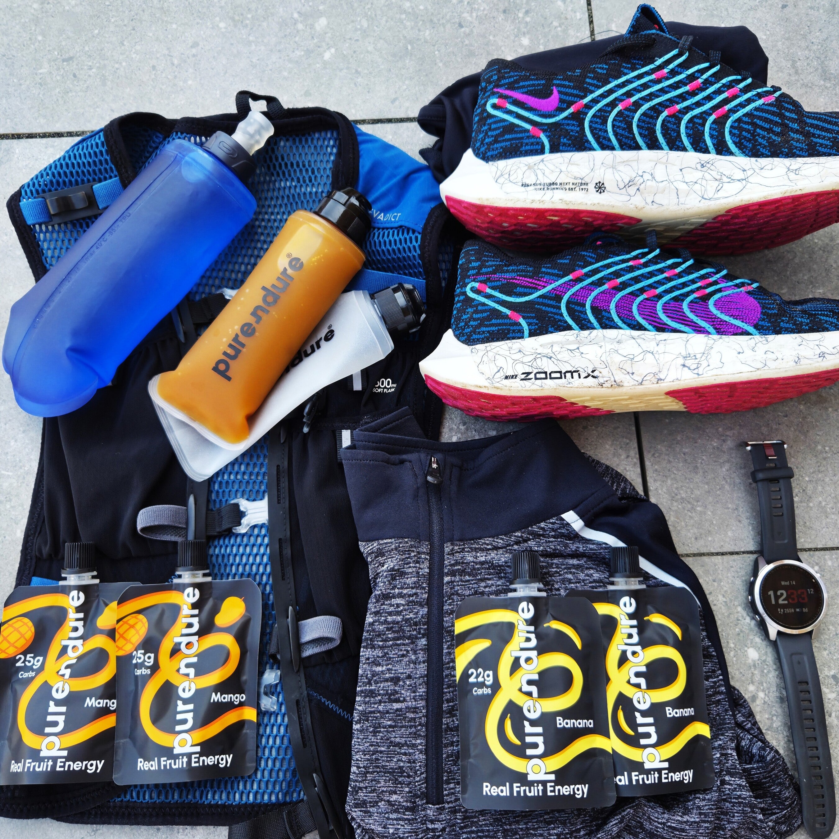 Sports gear and energy gels on a tiled floor