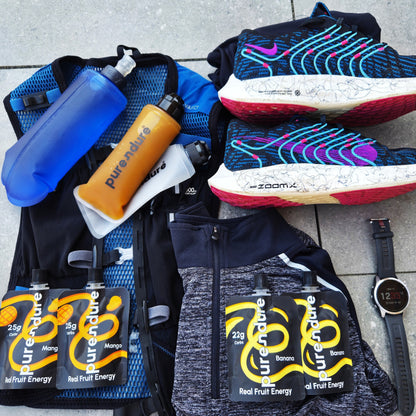 Sports gear and energy gels on a tiled floor