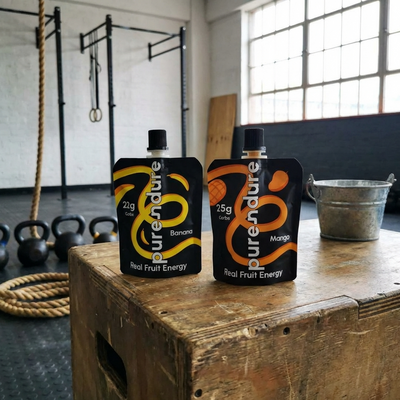 Two Purendure energy pouches on a wooden plyo box in a gym.